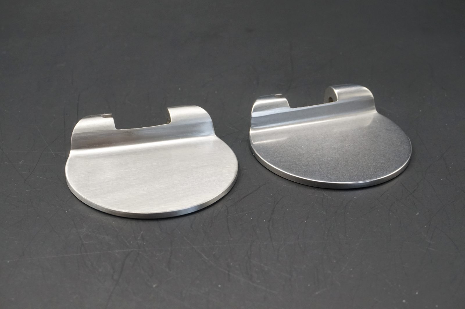 Real medical instrument metal parts showing surface finishing and edge quality comparison